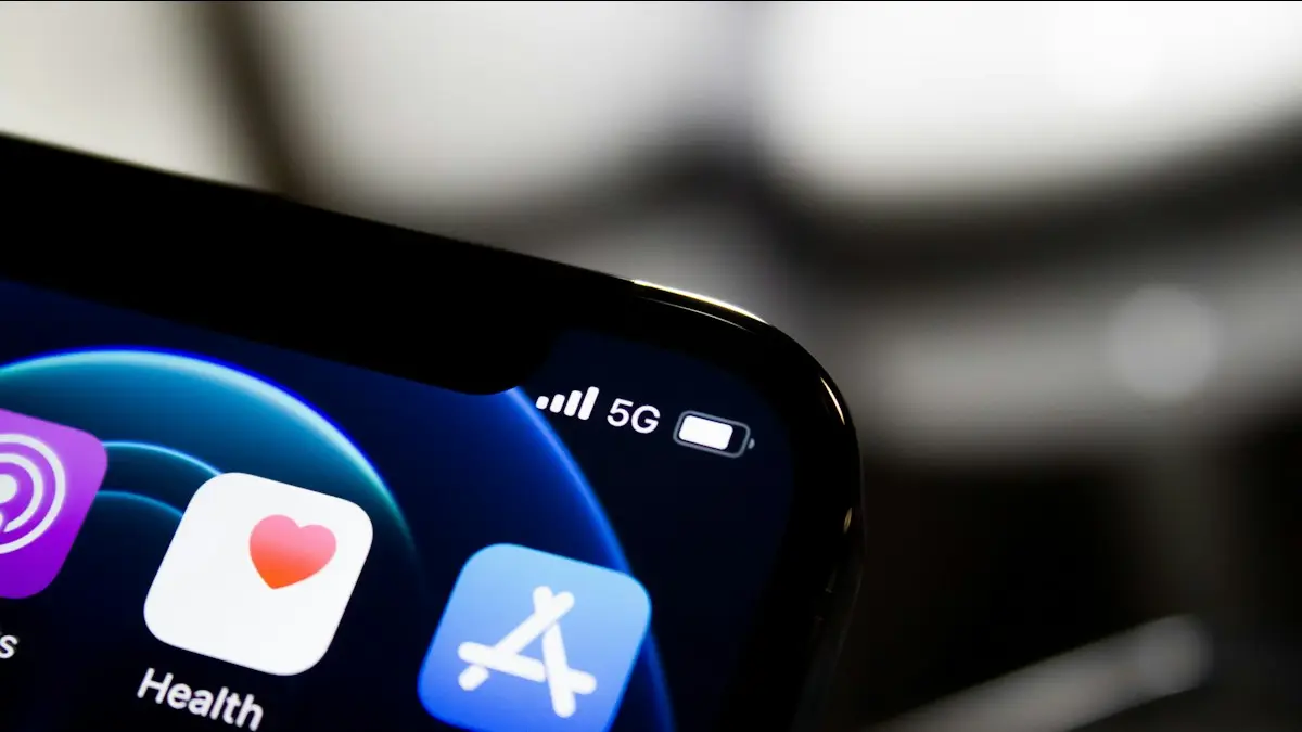 Black iphone 4 displaying icons