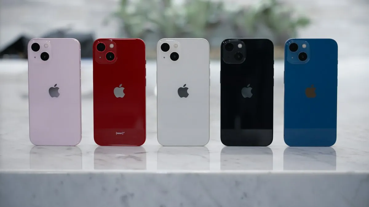 Four different colored iPhones sitting on a table