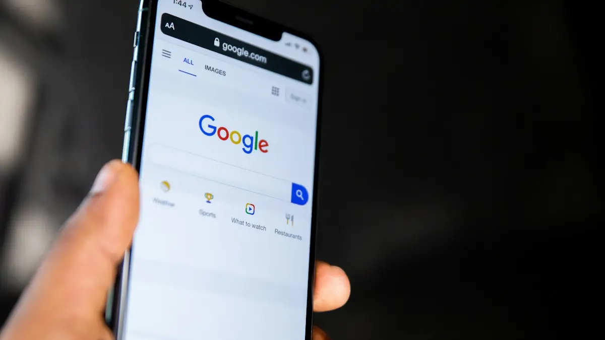 A hand holding a smartphone displaying the Google search engine homepage