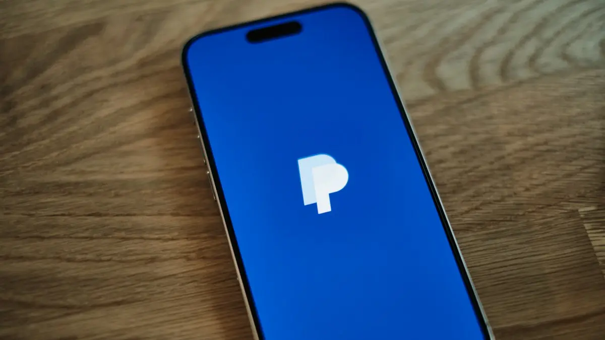 A blue iPhone sitting on top of a wooden table