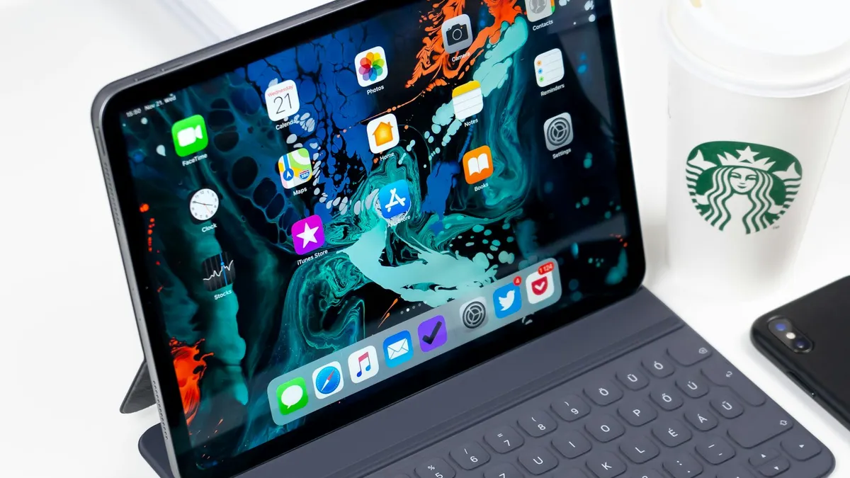 A turned on iPad lying on a desk