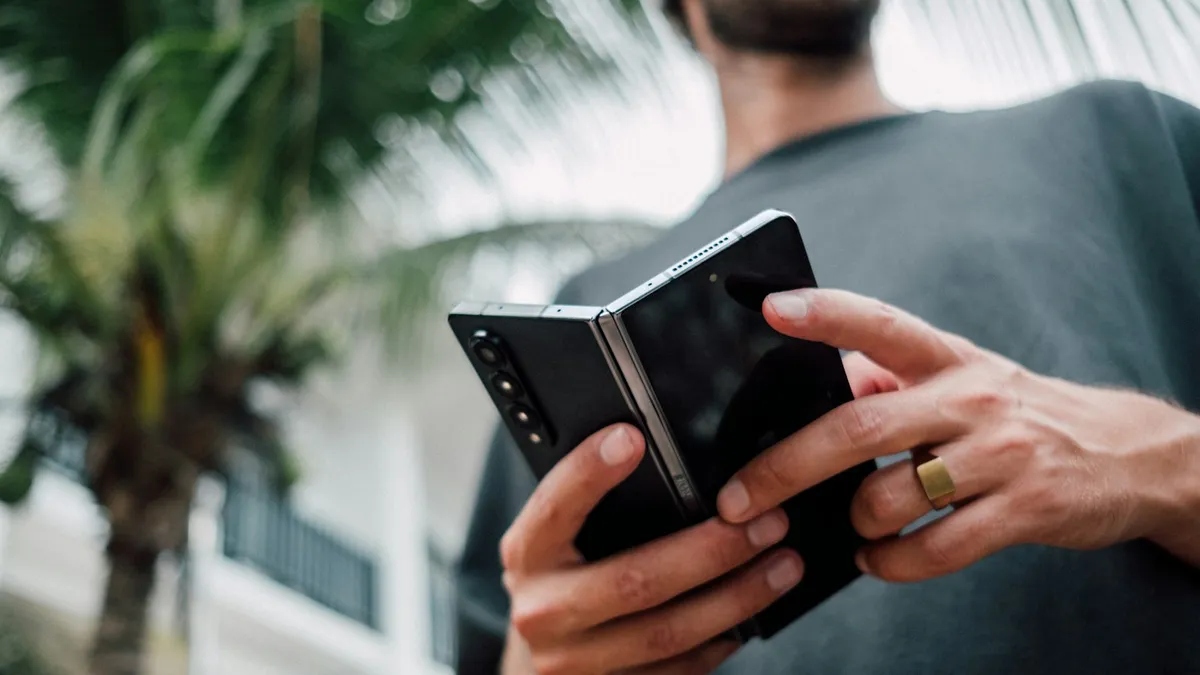 A man holding a smartphone in both hands