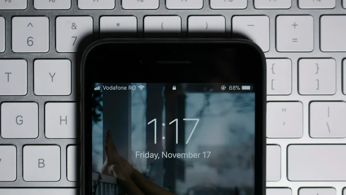 Black iPhone on gray computer keyboard