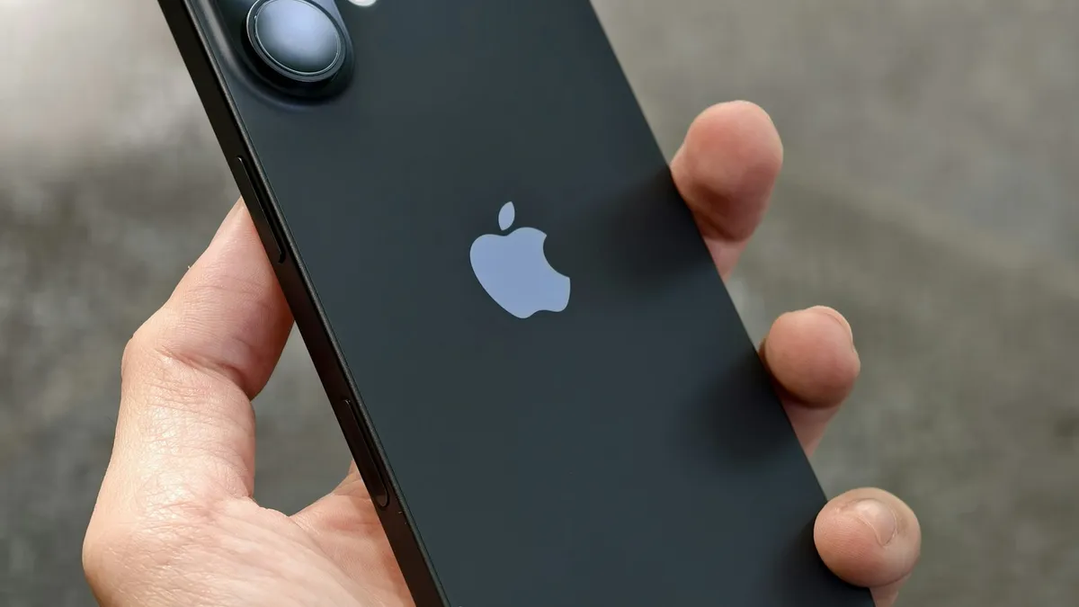 A person holding an iPhone in their hand