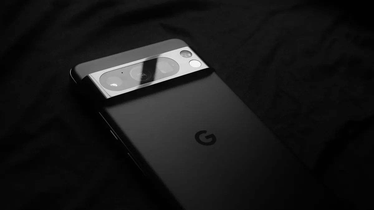 A close up of a cell phone on a black surface