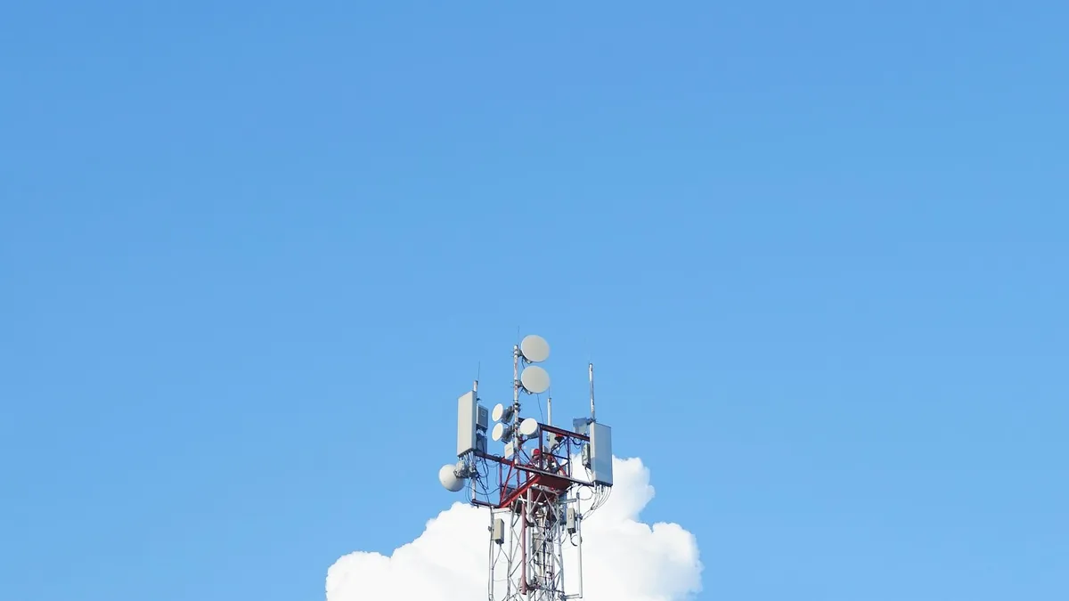 A cell phone tower against a blue sky