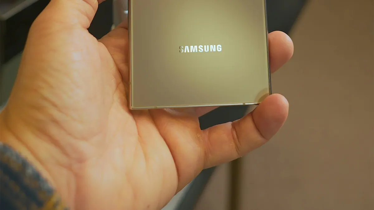 A hand holding the back of a Samsung Galaxy phone