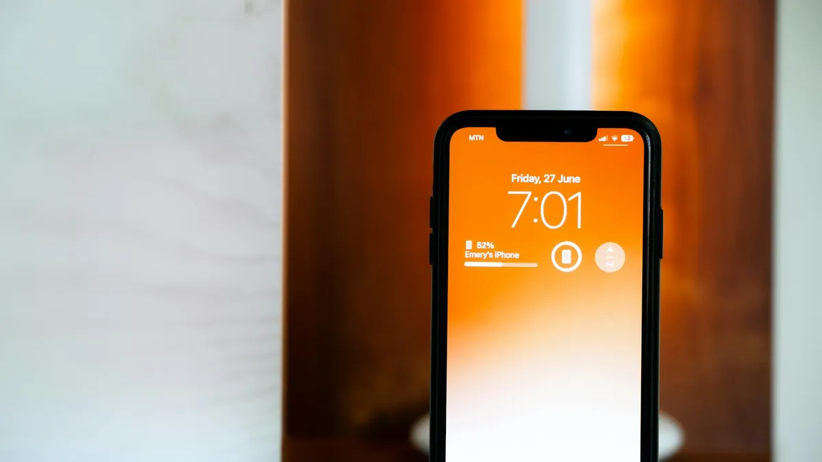 An iPhone displaying a locked orange screen