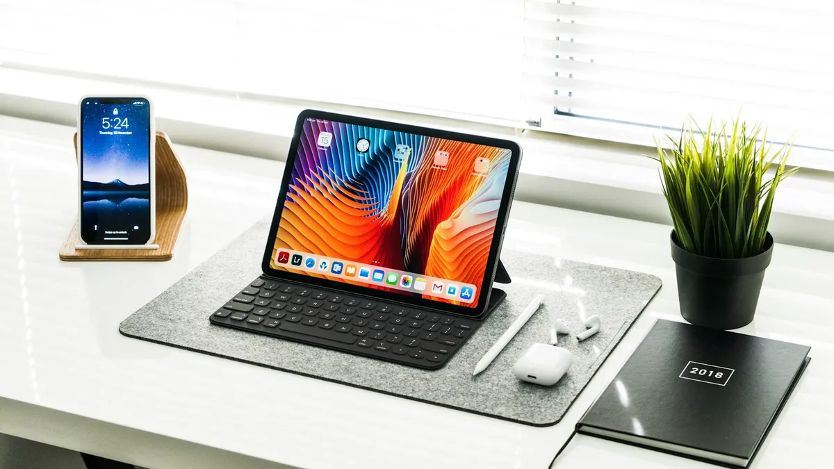 A black iPad held in a hand