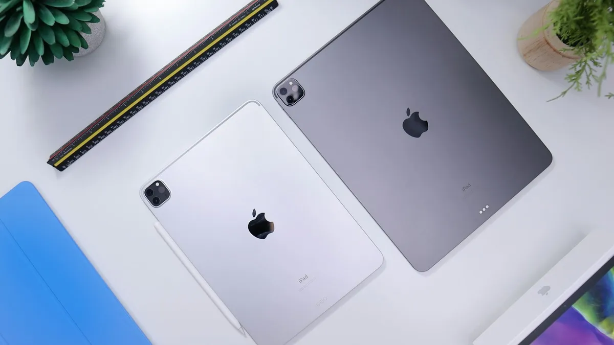 A silver iPad lying on a white table