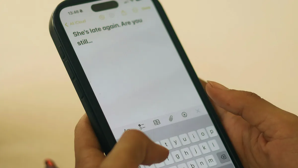 Hands typing on a smartphone with a message on screen